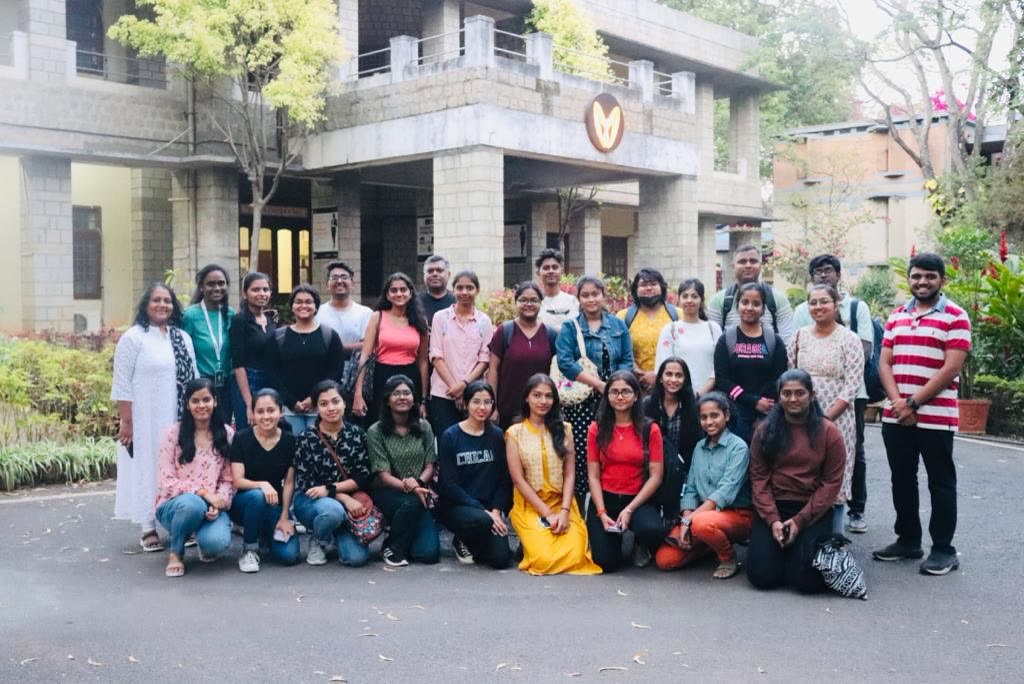 A large group photo outside a building