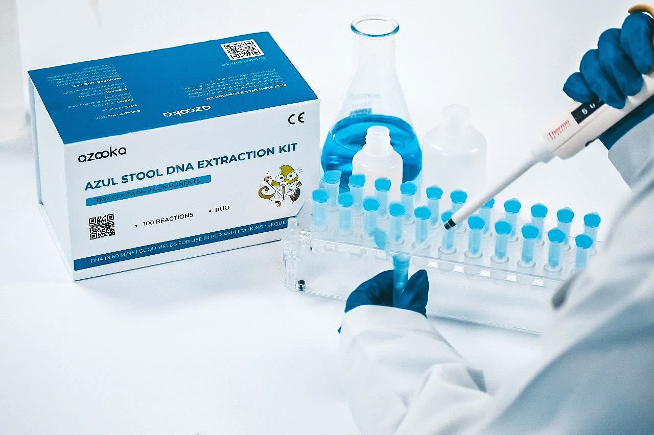 AZUL stool DNA extraction kit with a scientist pipetting samples