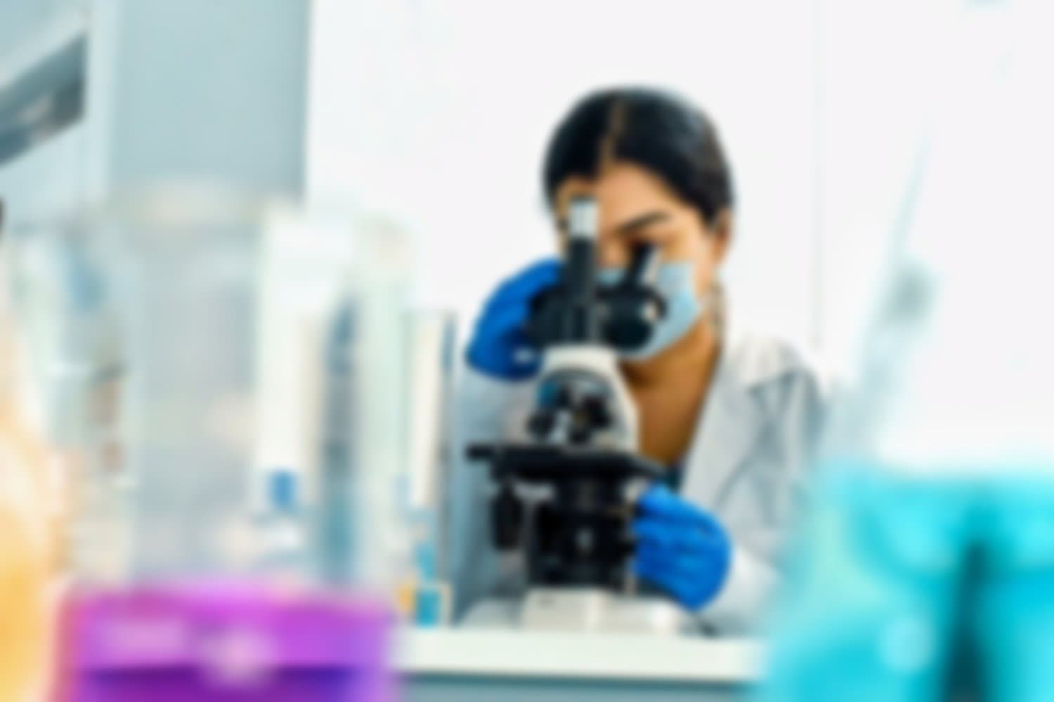 Azooka scientist working at a microscope